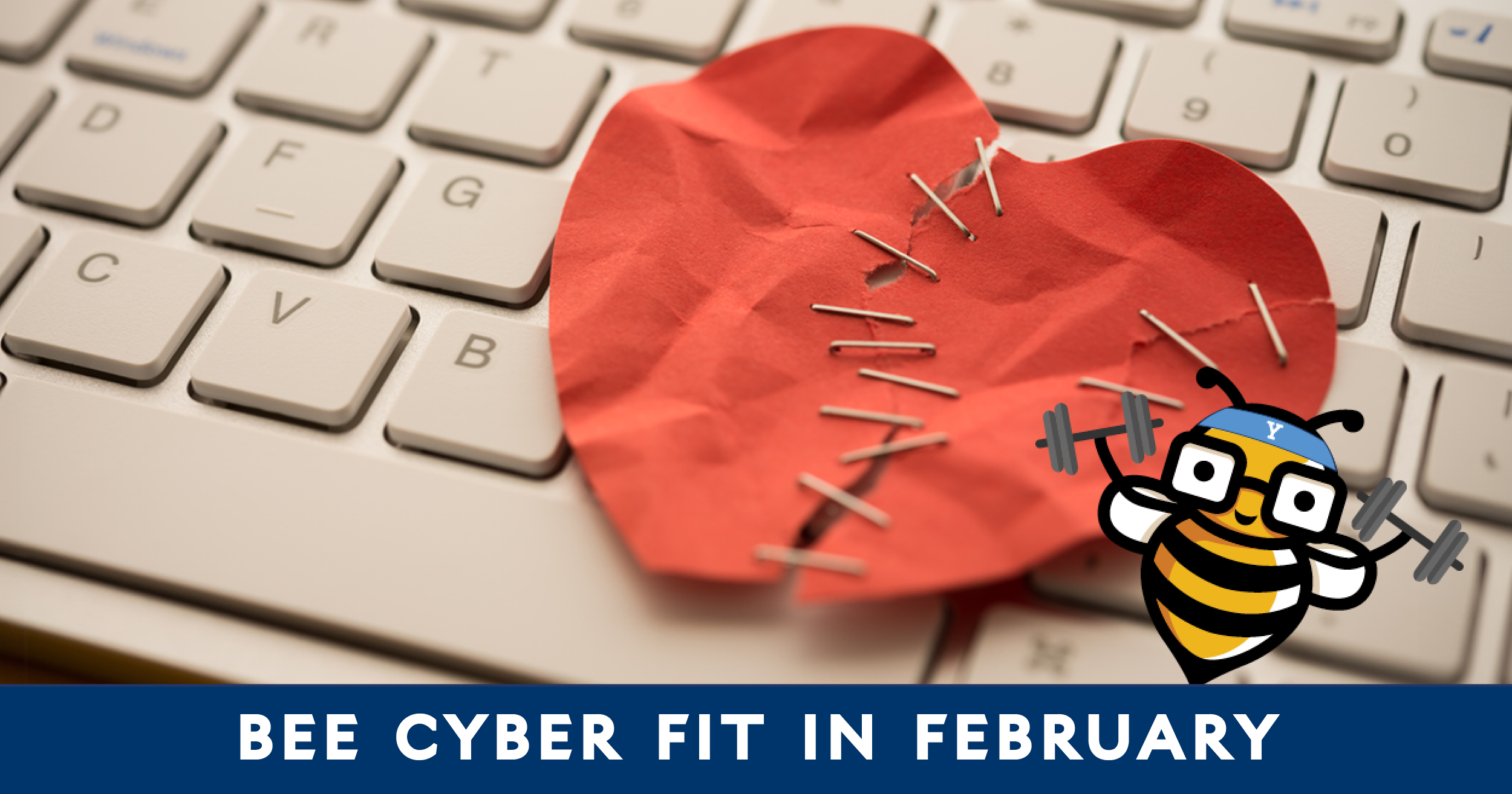 Bee Cyber Fit in February: Ripped paper heart stapled together on a keyboard